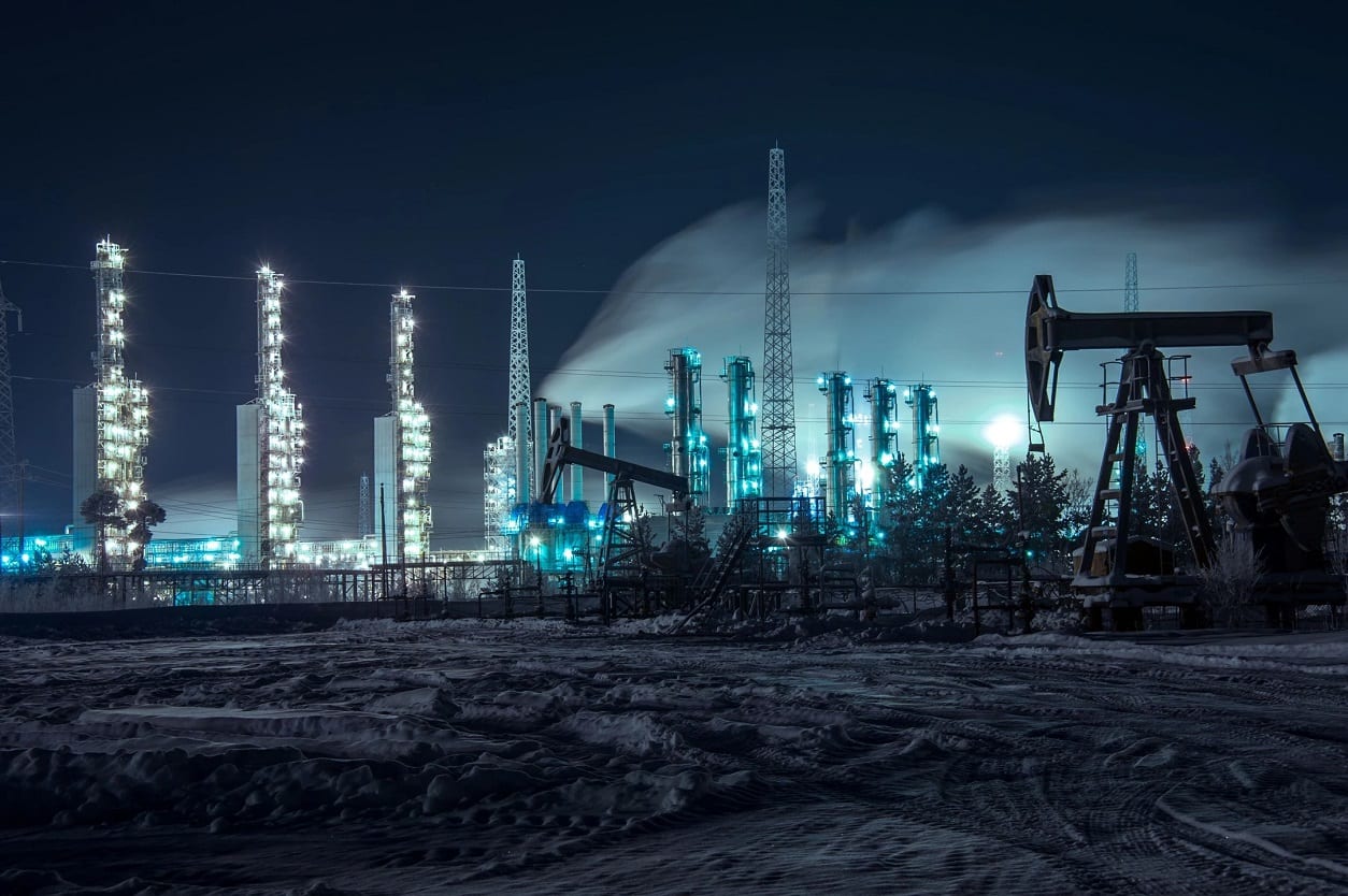 A night time scene of an oil field.