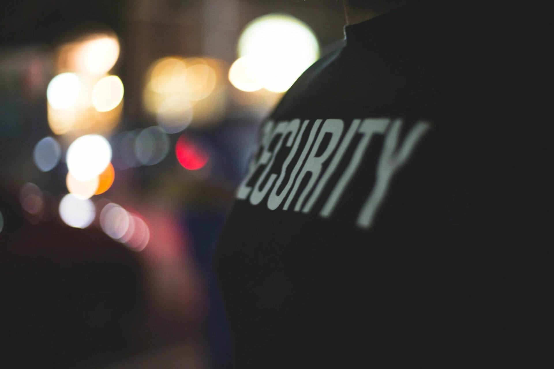 A security guard is standing in front of the lights.